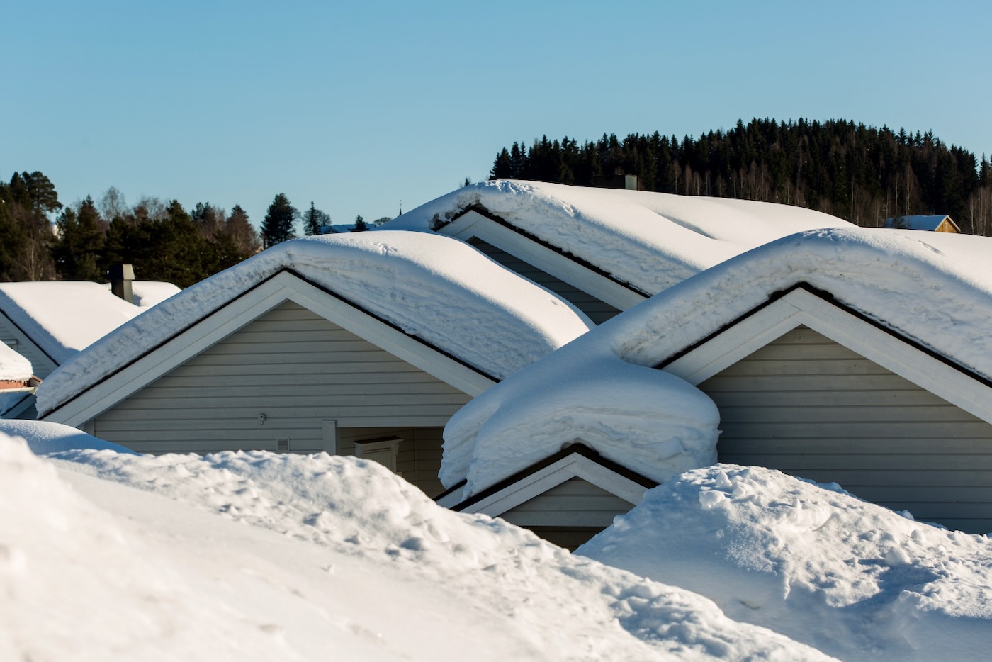 Heavy snow on residential rooftops.