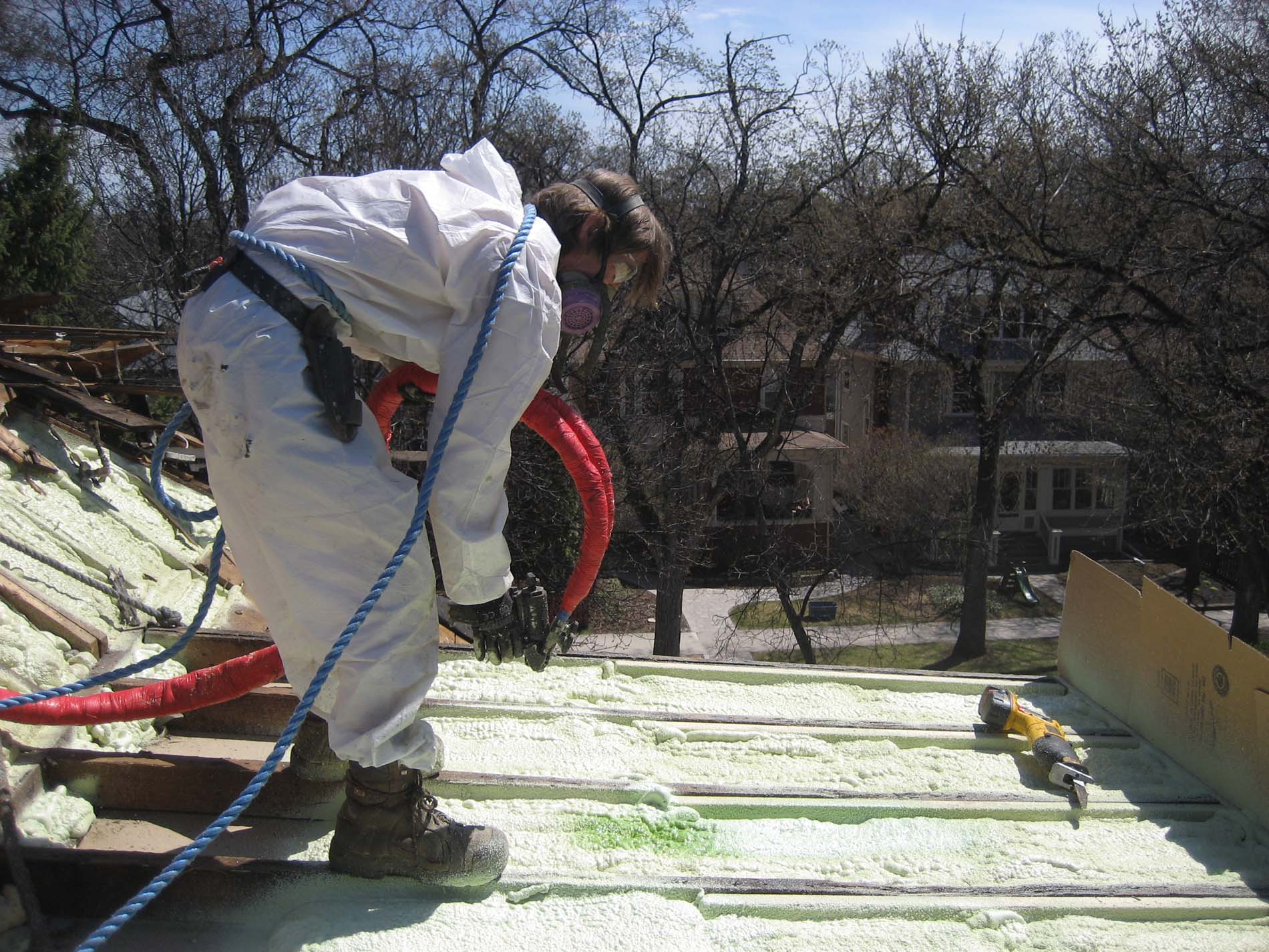 Polurethane spray foam being applied 3" thick to slopes of a 1 3/4 storey in the West End.