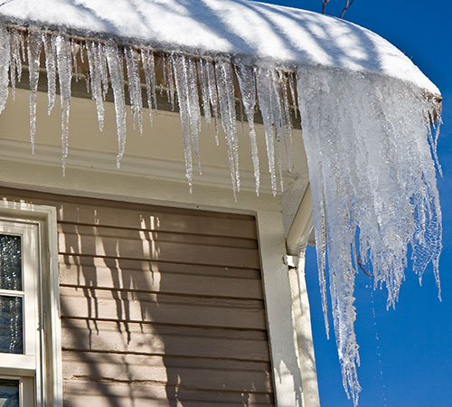 Large icicles hanging from roof edge.