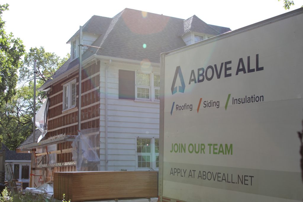 House under renovation with Above All work truck parked in front.